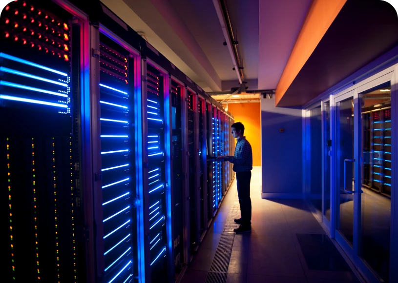 Person managing servers in dimly lit room